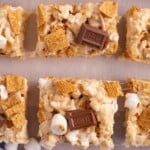 Crispy rice cereal treats topped with marshmallows, chocolate and graham cracker cereal.