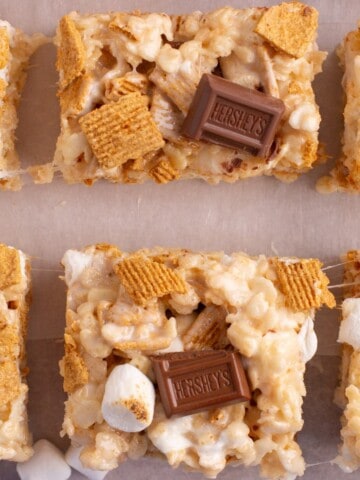 Crispy rice cereal treats topped with marshmallows, chocolate and graham cracker cereal.