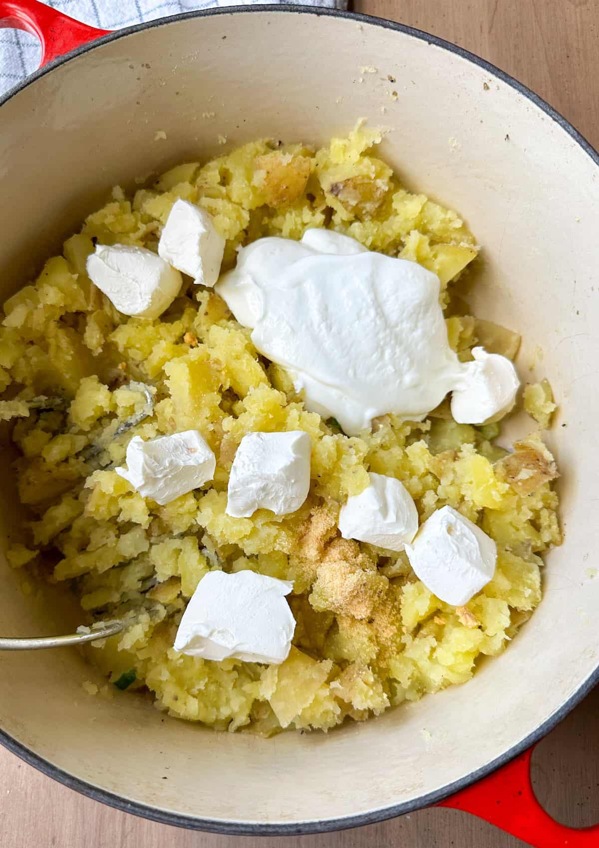 Cream cheese and sour cream on top of mashed potatoes.