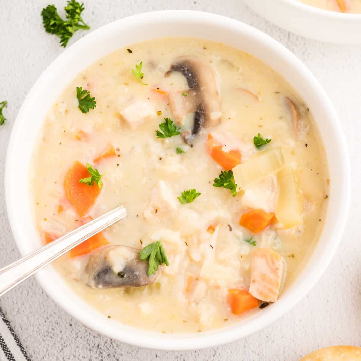 Creamy soup with rice and turkey in a bowl.