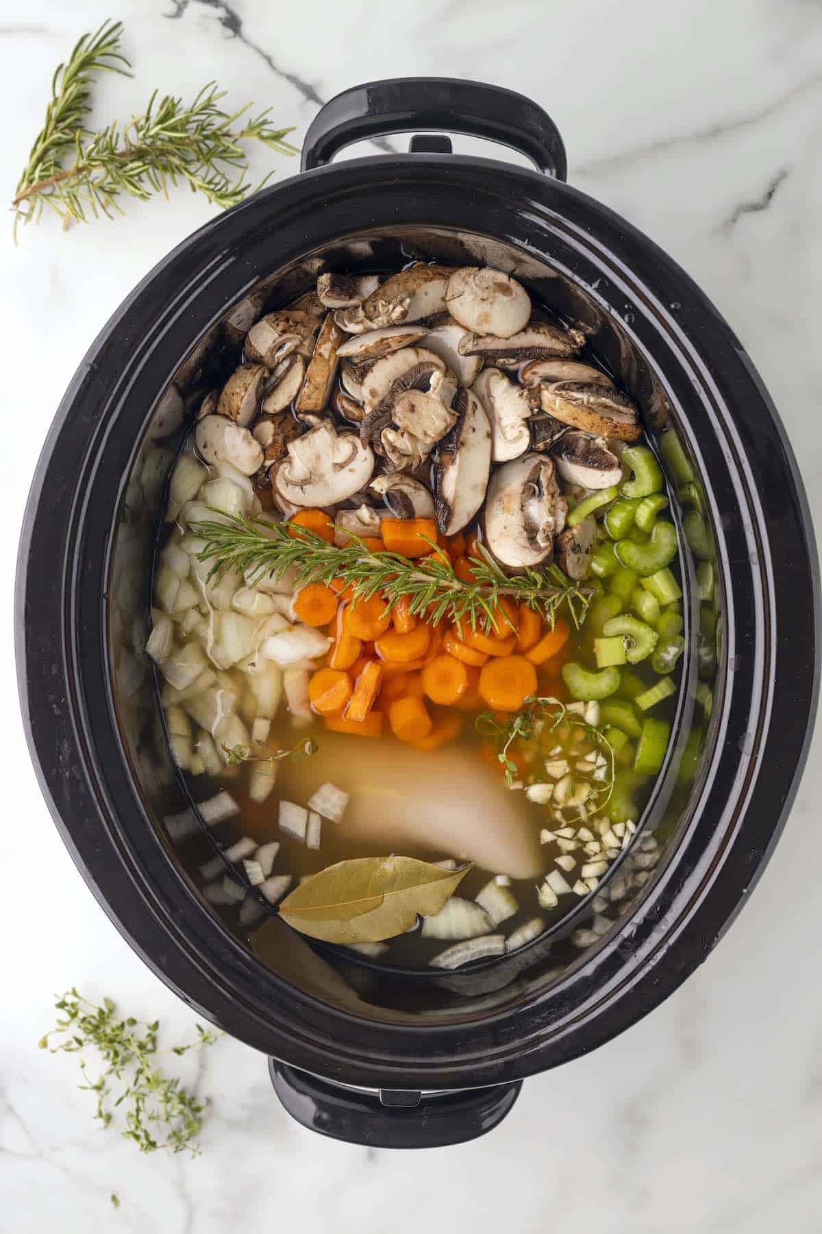 Chicken and wild rice soup ingredients in the crock pot.