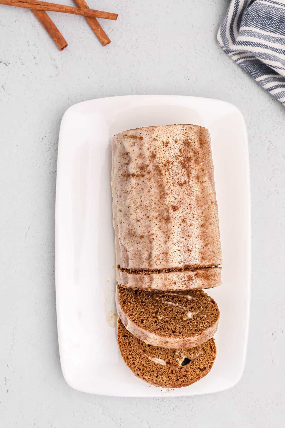A sliced and rolled log type cake made with gingerbread spices.