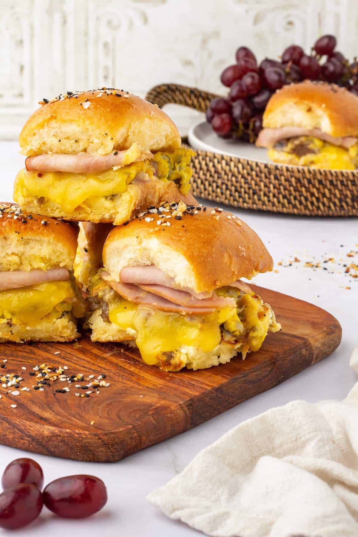 Stacked breakfast sliders showing eggs, ham and cheese.