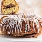 Slice of moist sour cream coffee cake showing cinnamon streusel swirl.