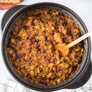 A pot of baked beans with cooked ground beef.