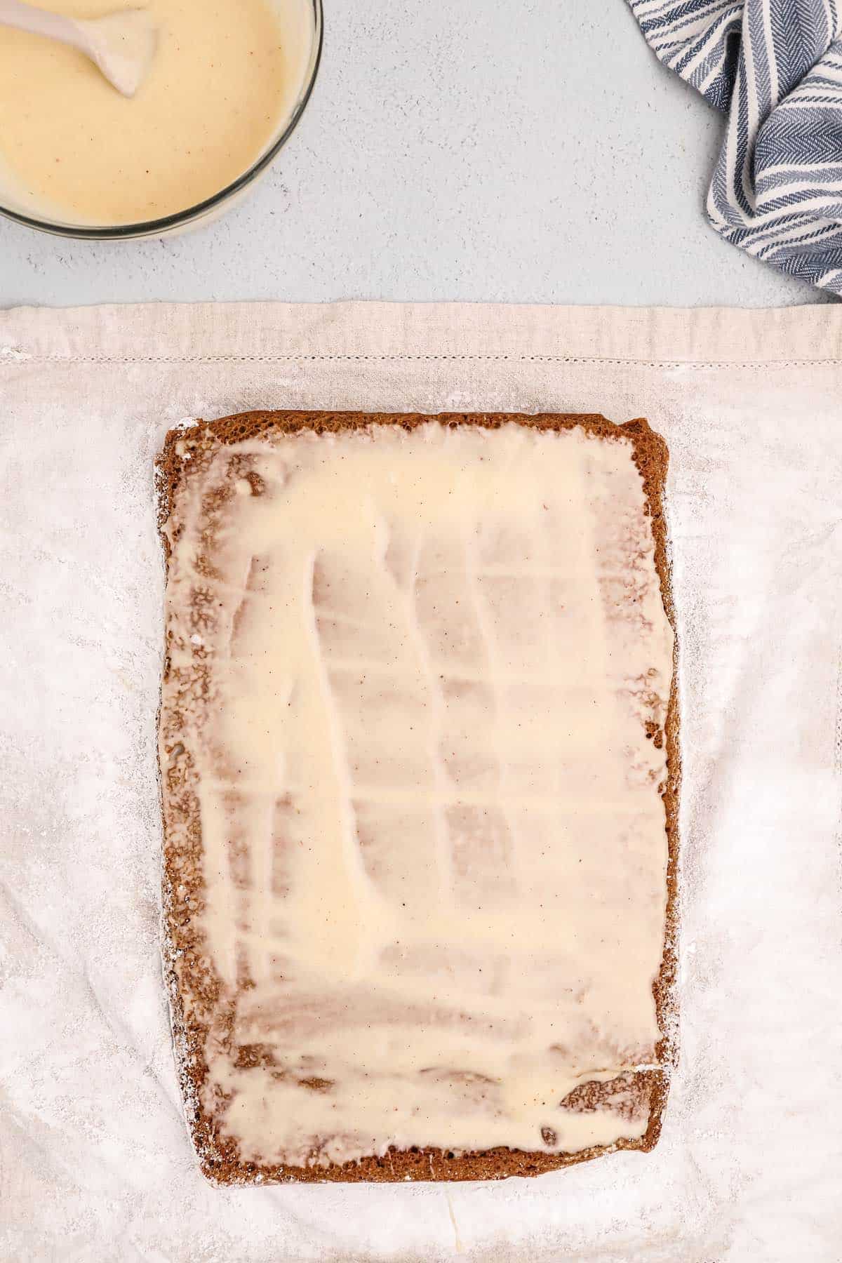 Gingerbread icing spread onto a cake.