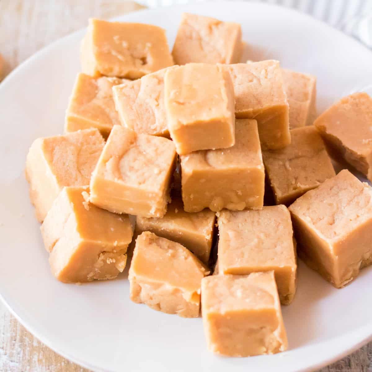 A plate of stacked peanut butter fudge on a plate.