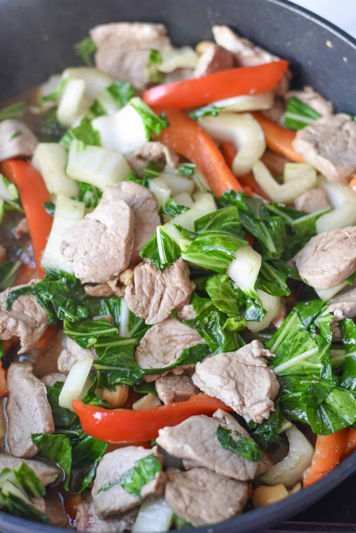 Low carb pork stir fry with bell peppers and bok choy mixed together.