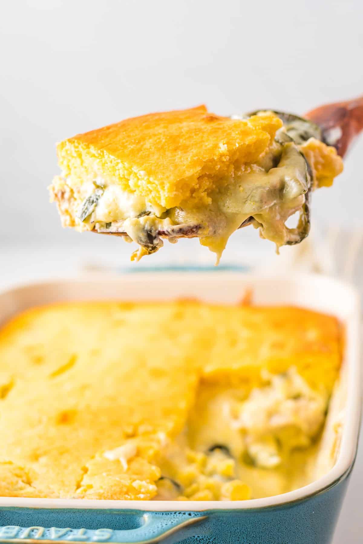 A slice of chile rellenos on a spatula.