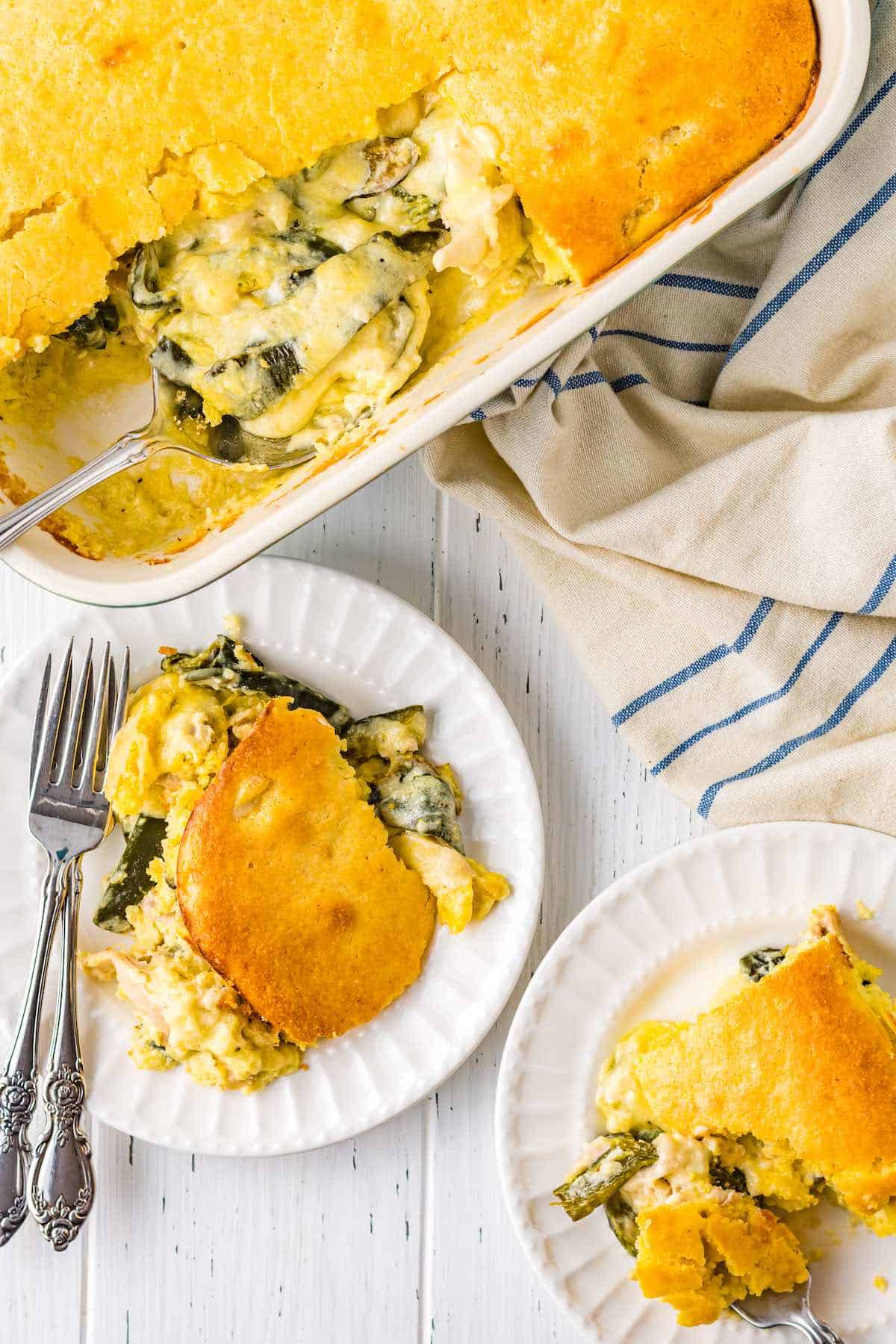 Plated chile rellanos with a creamy sauce.