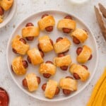 Hot dogs bites wrapped in dough on a plate.