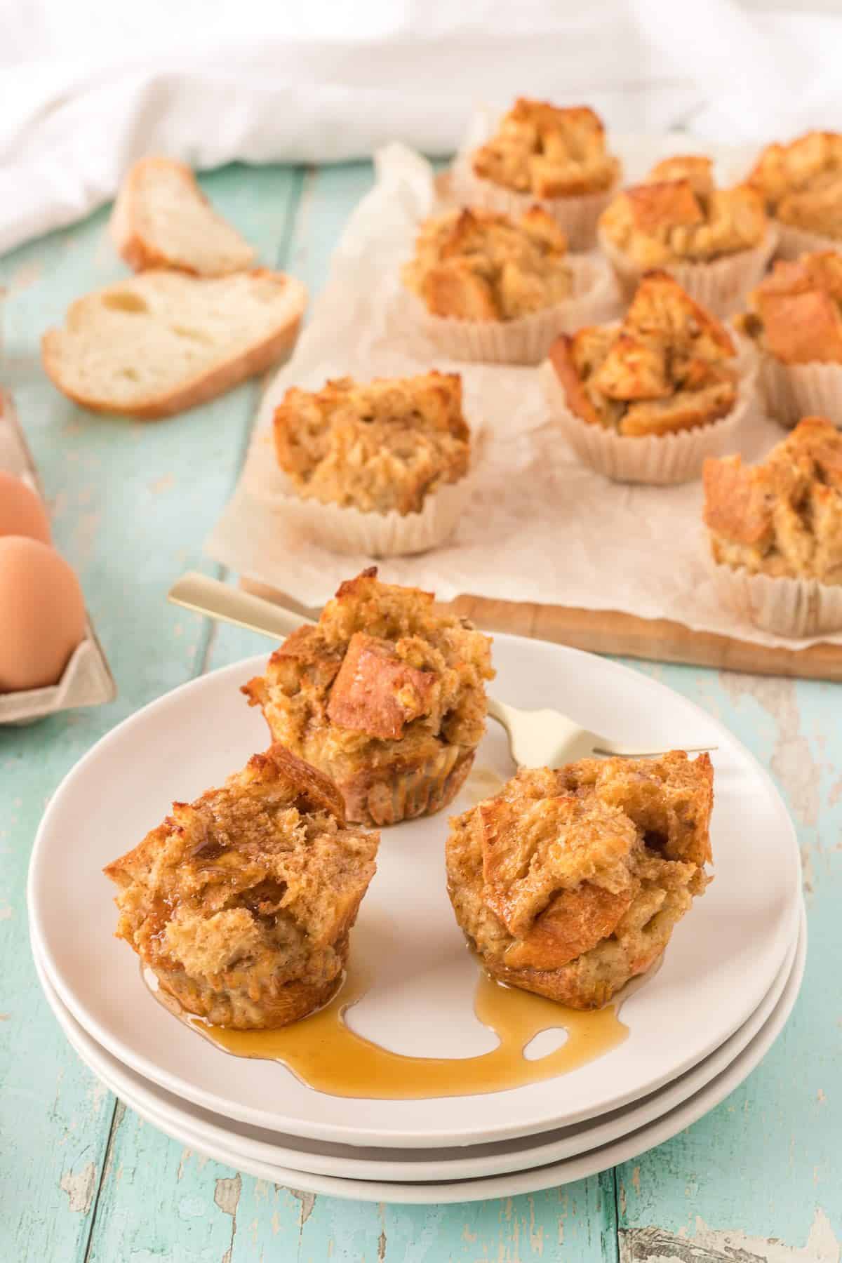 Plated French toast cups drizzed with syrup.