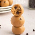 Three protein bites with chocolate chips stacked.