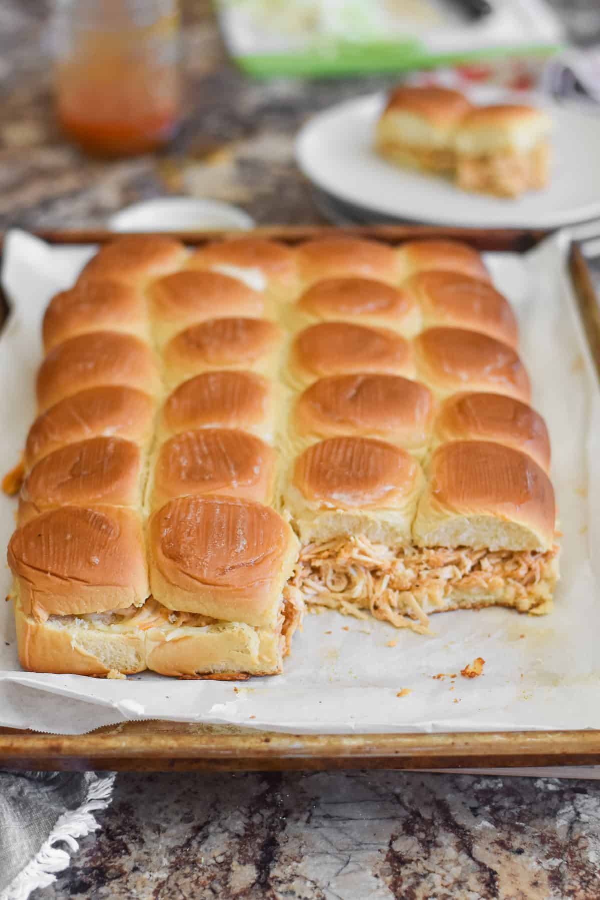 A tray of buffalo chicken sliders on Hawaiian rolls.