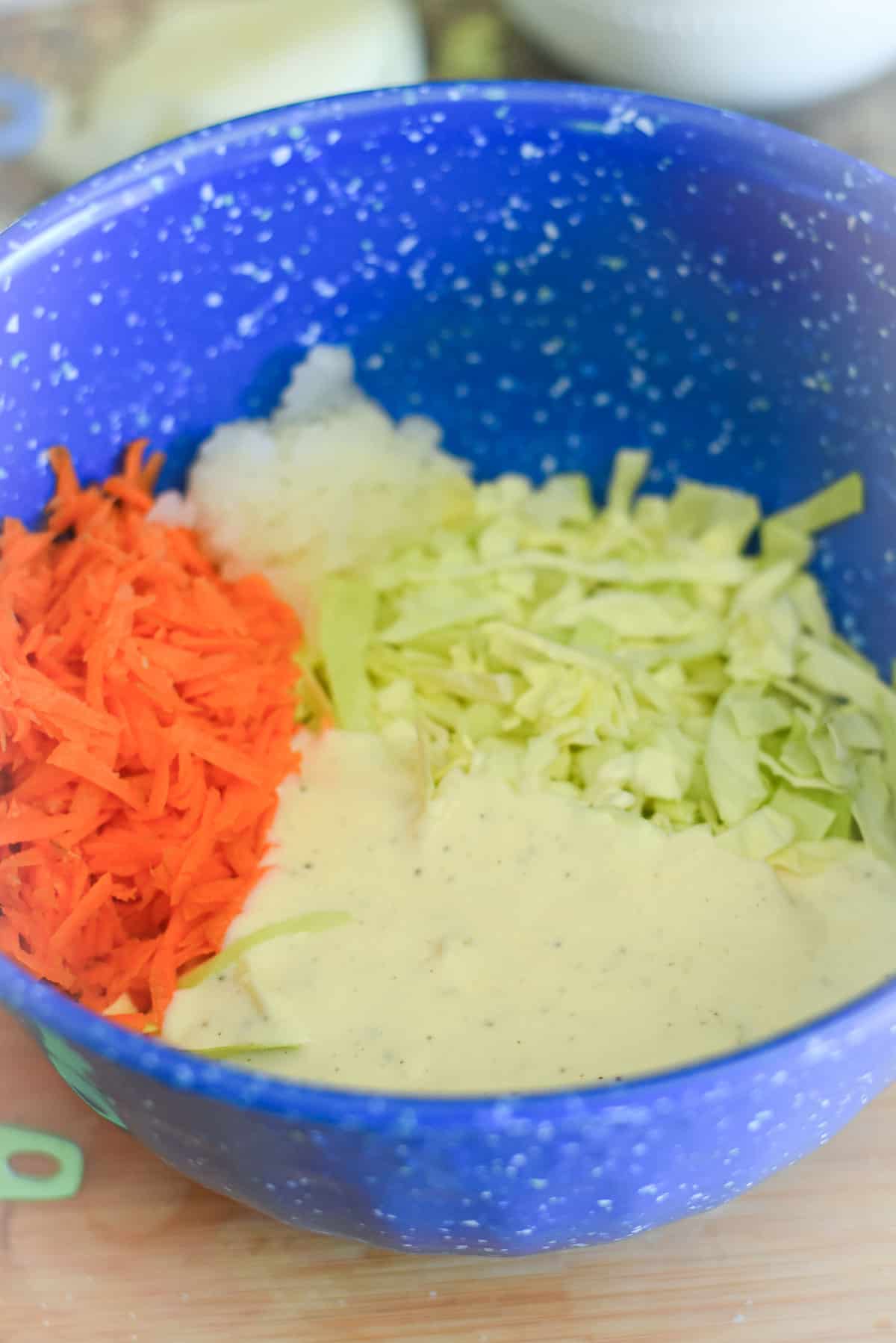 Coleslaw with dressing in a bowl.