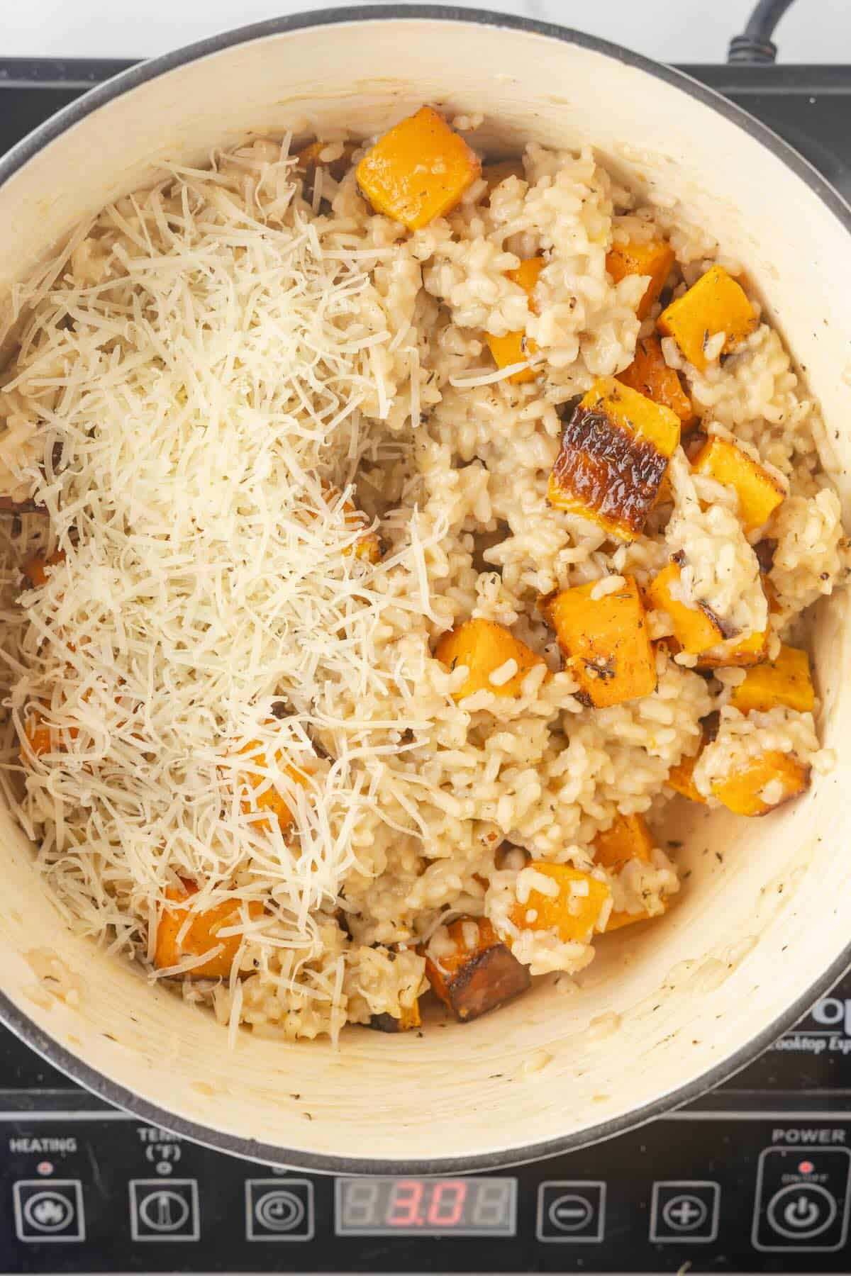 Cooked butternut squash and Arborio rice topped with Parmesan cheese.
