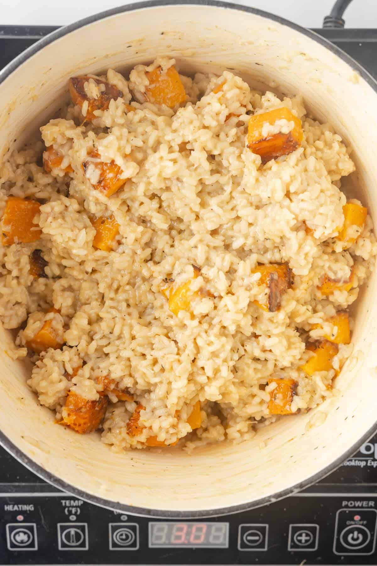 A pot of cooked butternut squash risotto.