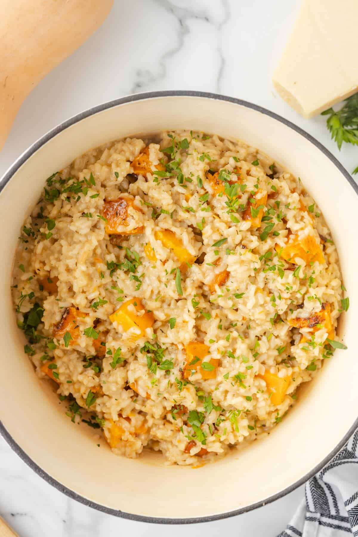 A Dutch oven filled with cooked butternut squash and rice.