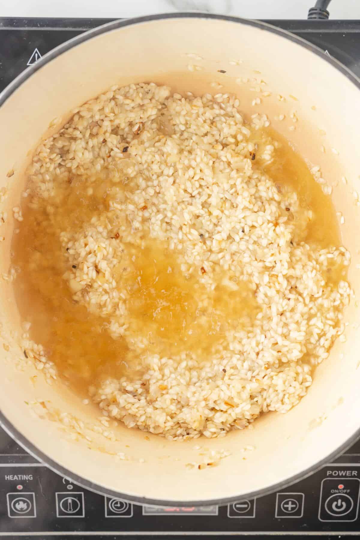 Arborio rice in a Dutch oven with vegetable stock.