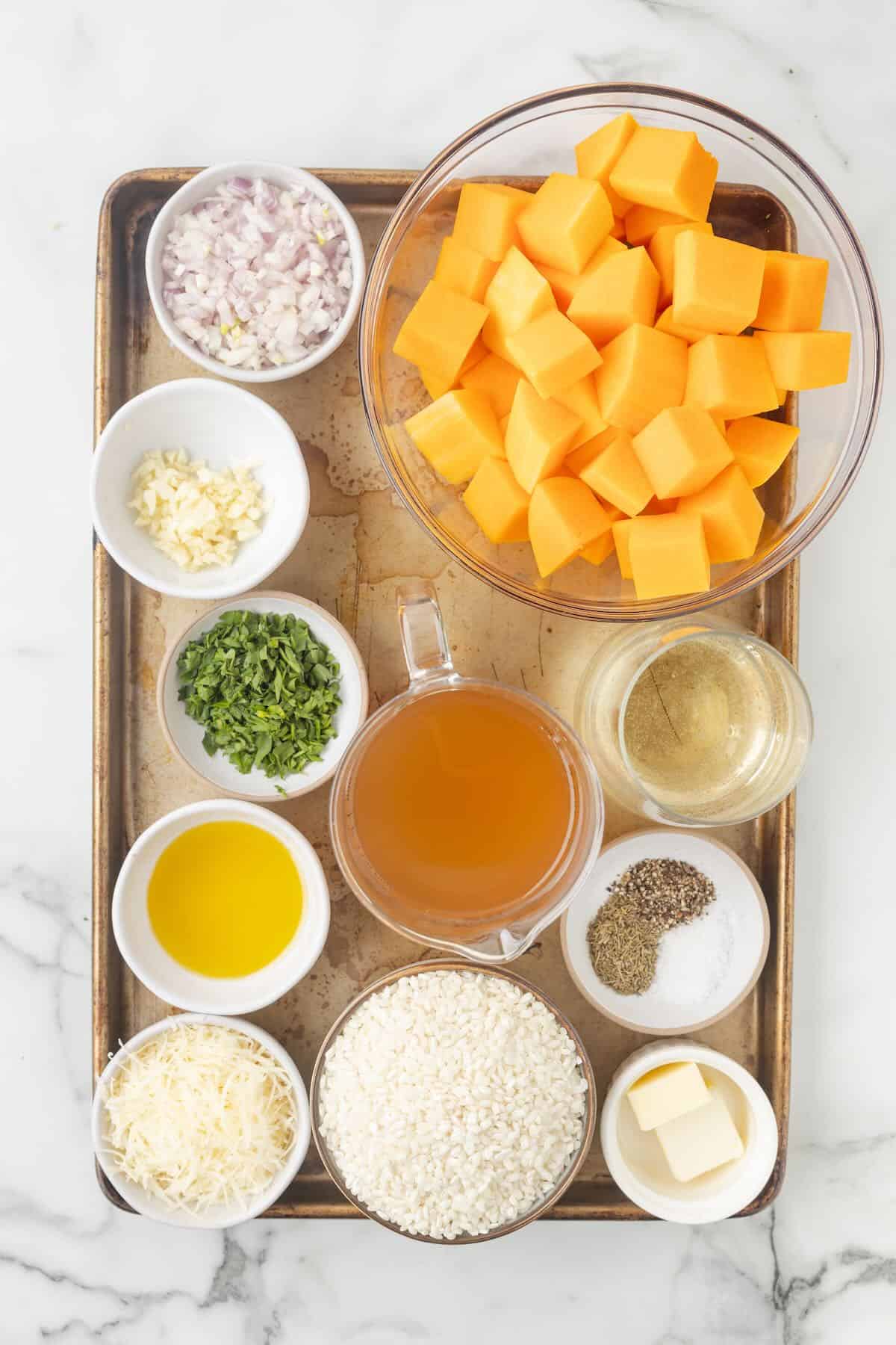A sheet pan of portioned ingredients to make a risotto with butternut squash.
