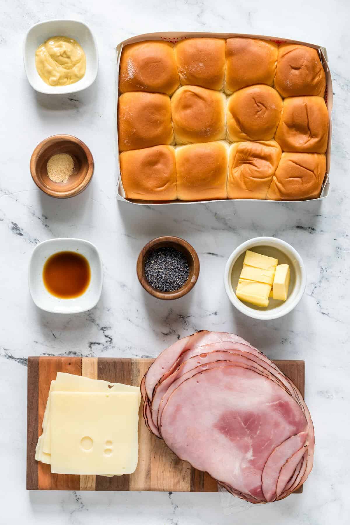 Ingredients for a funeral sandwiches recipe with Hawaiian rollsham cheese and seasonings.