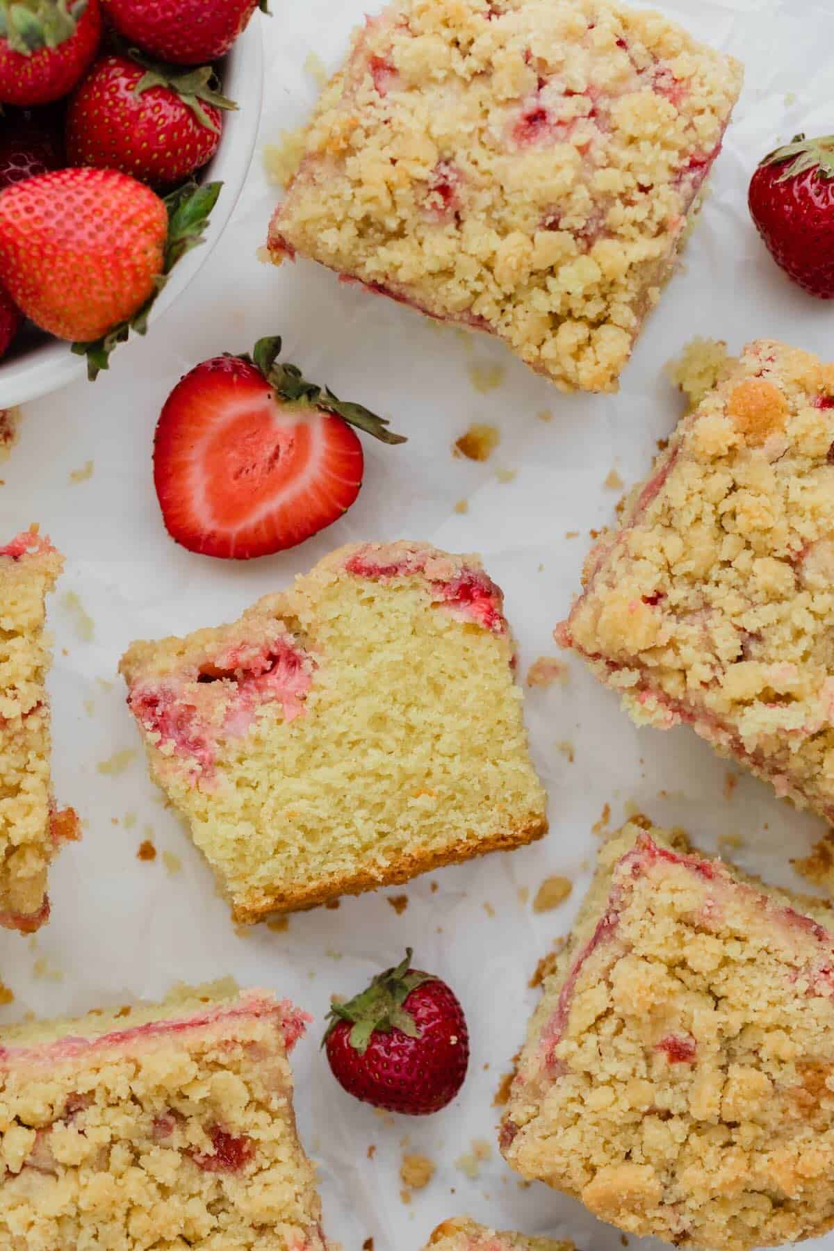 Strawberry cake squares on a countertop.