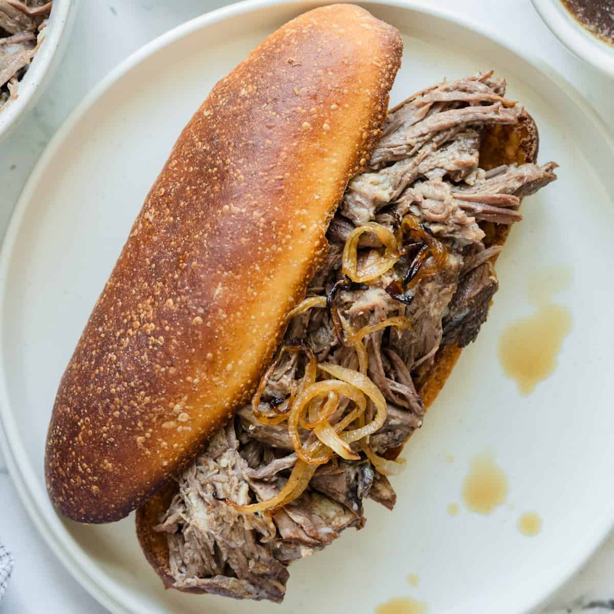 A French dip sandwich on a toasted roll.