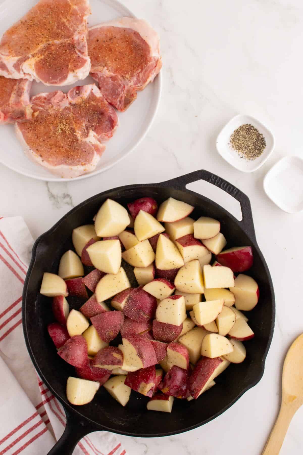 Red potato chunks in a cast iron skillet.