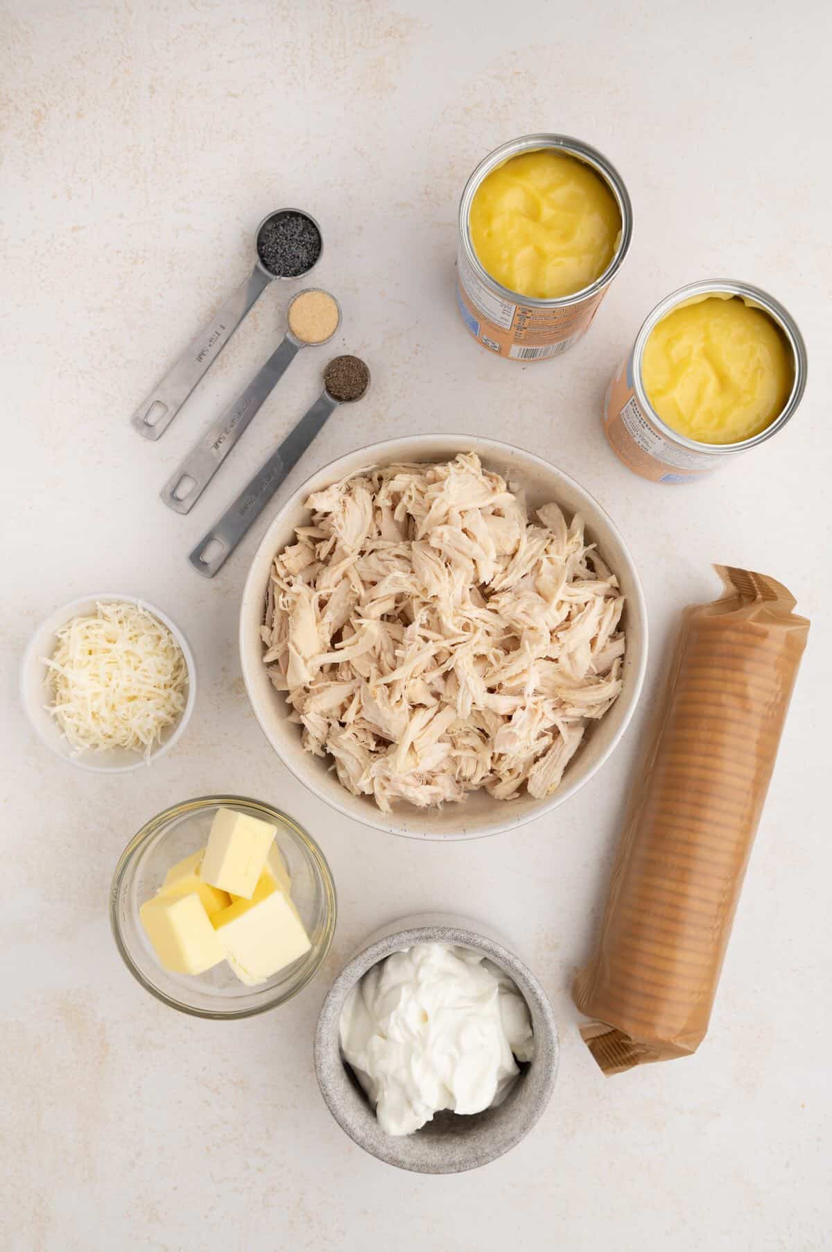 Ingredients for poppy seed chicken casserole including chicken, sour cream, soup, poppy seeds, and Ritz crackers.
