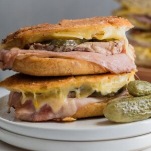 Cubano sandwiches with pickles, ham, pork and mustard.