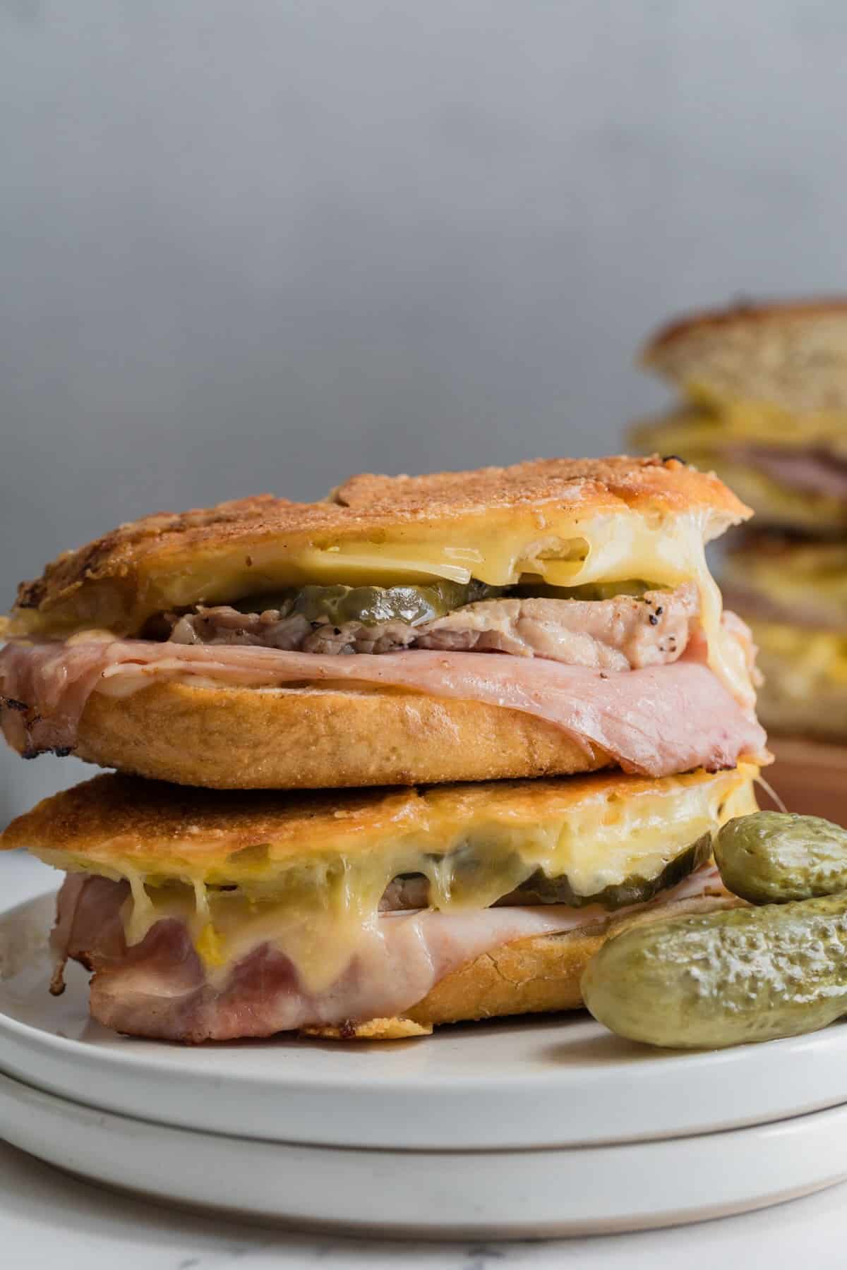 Cuban sandwich with ham and cheese and pickles.