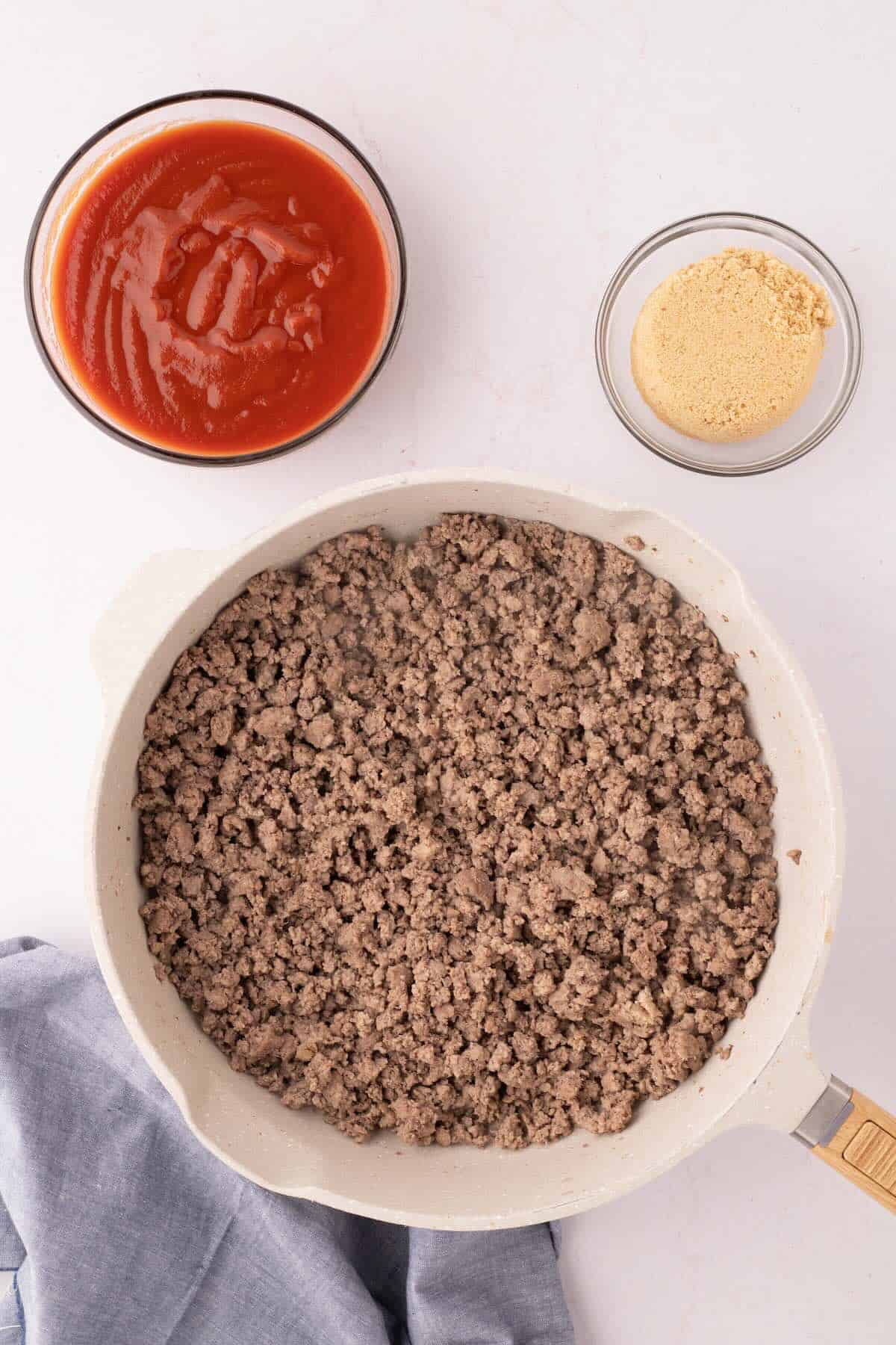 Browned ground beef in a skillet.