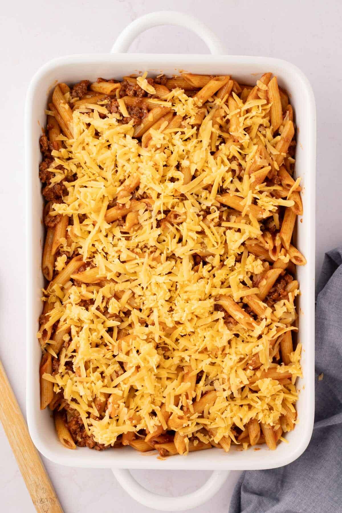 Noodles, sauce and ground beef in a casserole topped with cheese.