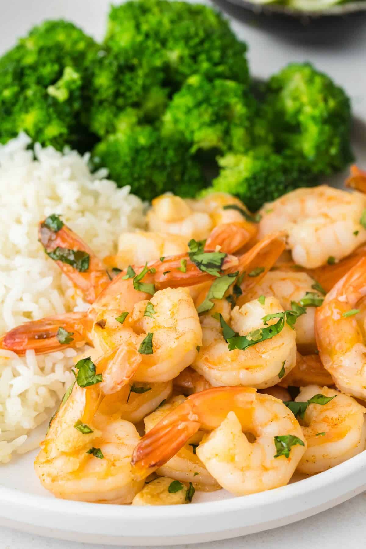 Shrimp with rice and broccoli on a plate.