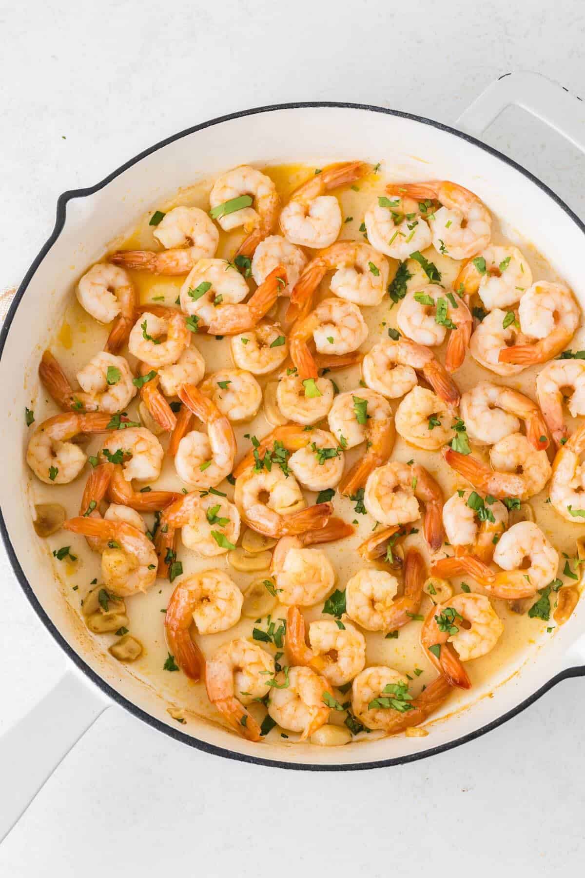 Shrimp with garlic sauce and topped with fresh parsley.