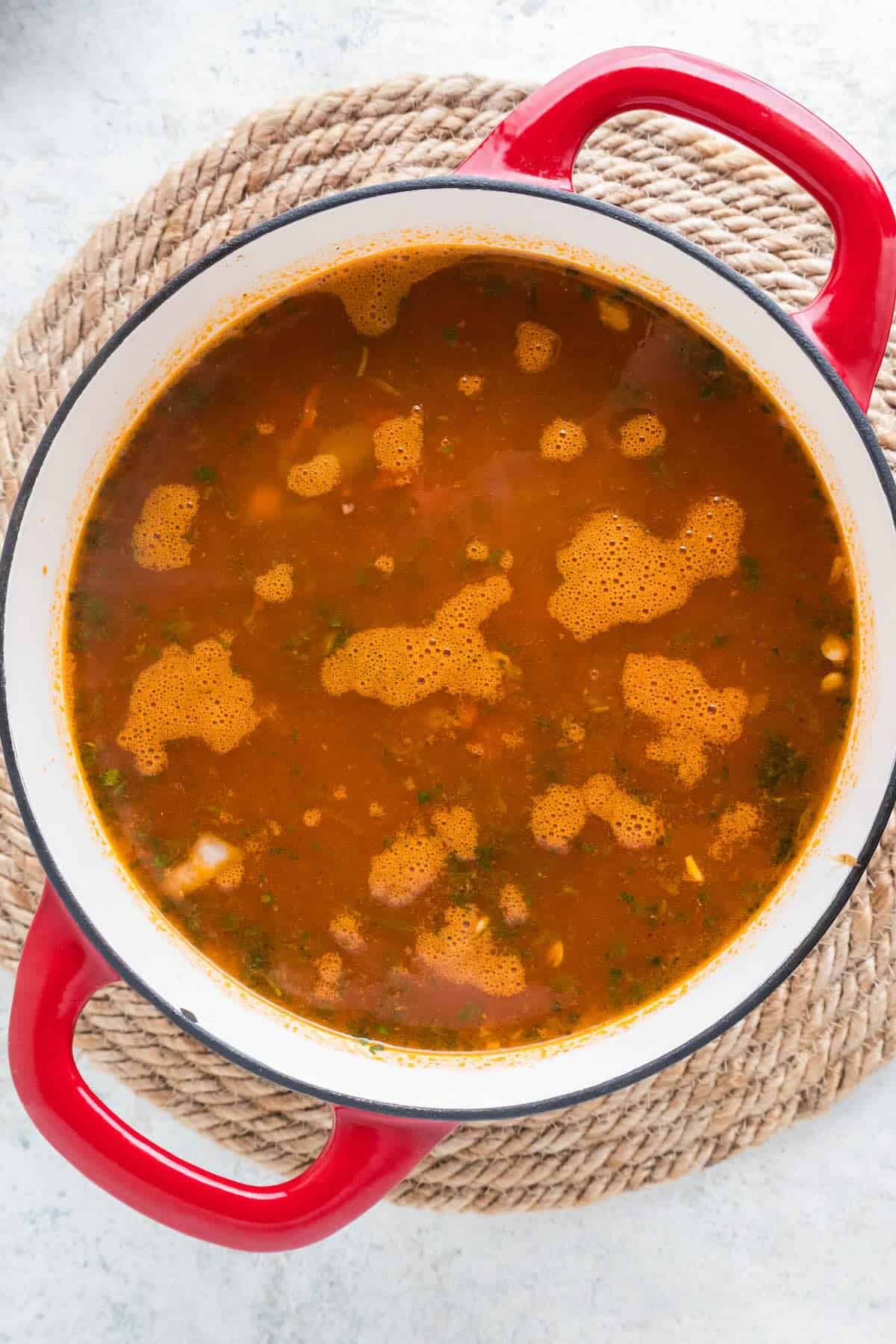 A Dutch oven full of vegetable lentil soup.