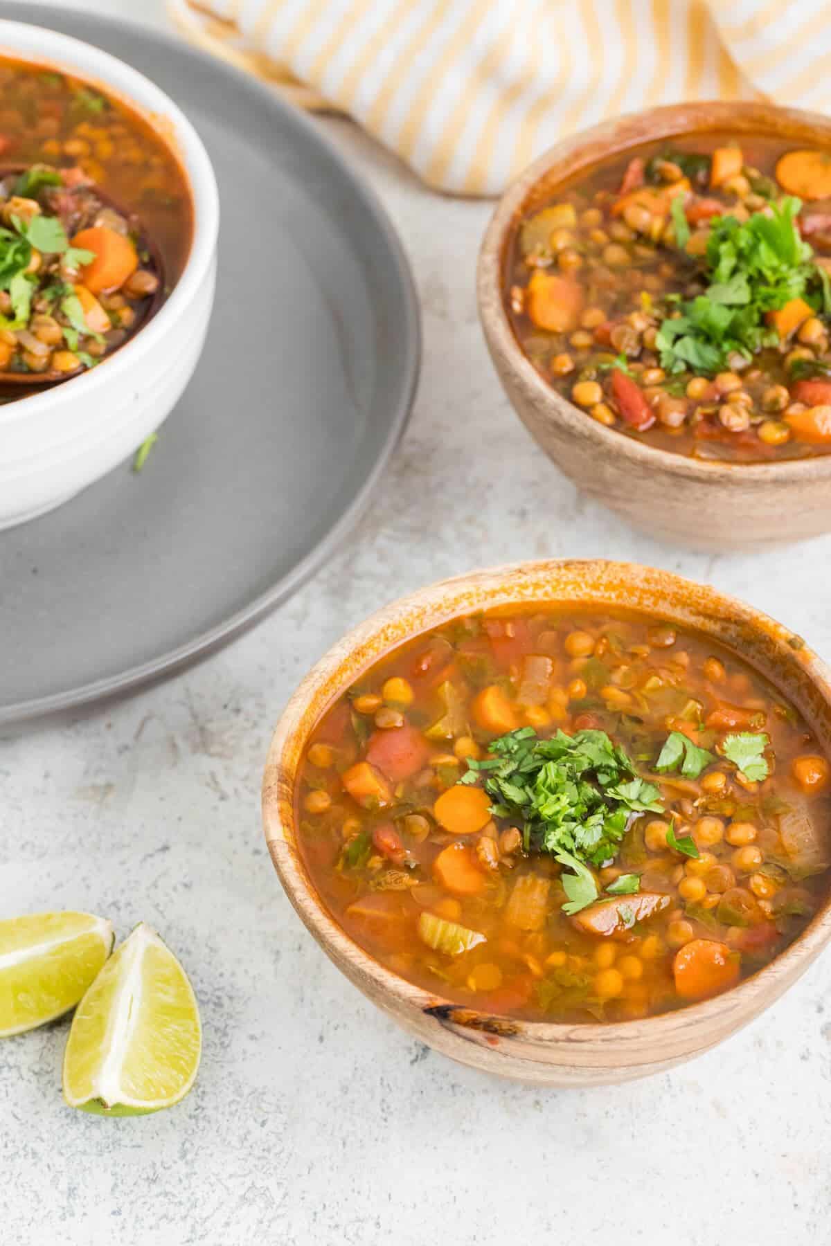 Cozy bowls of lentil soup topped with cilantro.