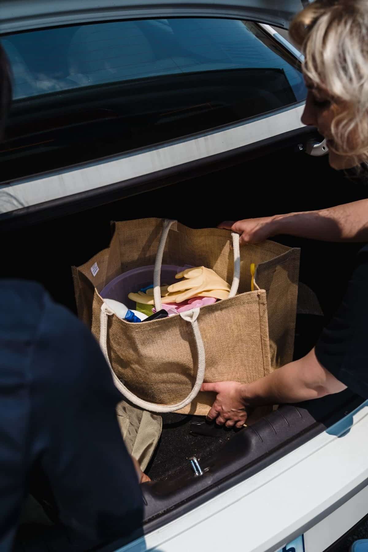A grocery bag in the trunk of a car.