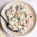 A bowl of Mediterranean tuna salad made with Greek yogurt, feta cheese, kalamata olives, and fresh dill.