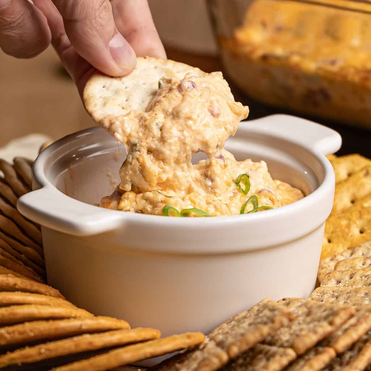 A scoop of slow cooker reuben dip on a tortilla chip.