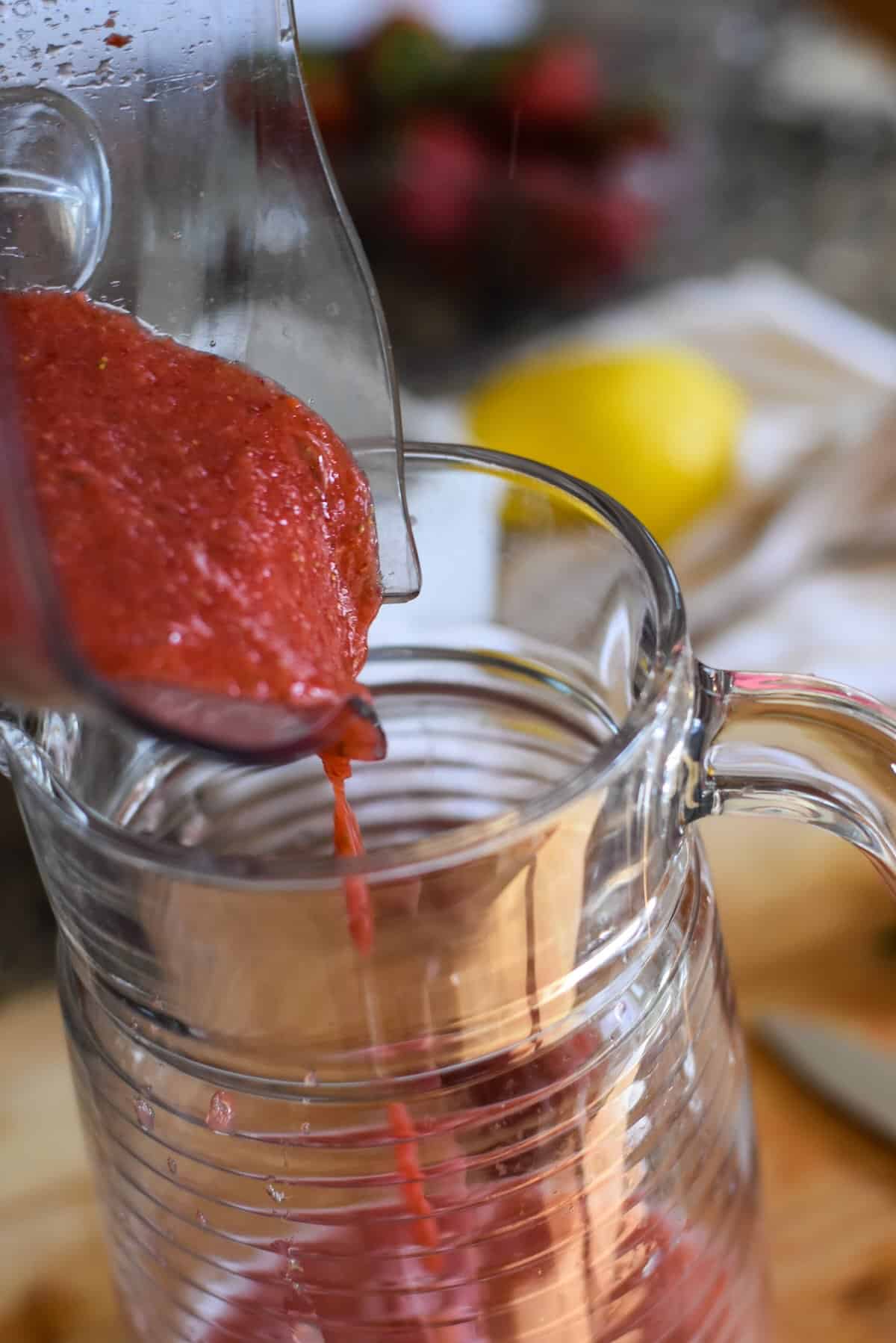 Strawberry lemonade in a pitcher.