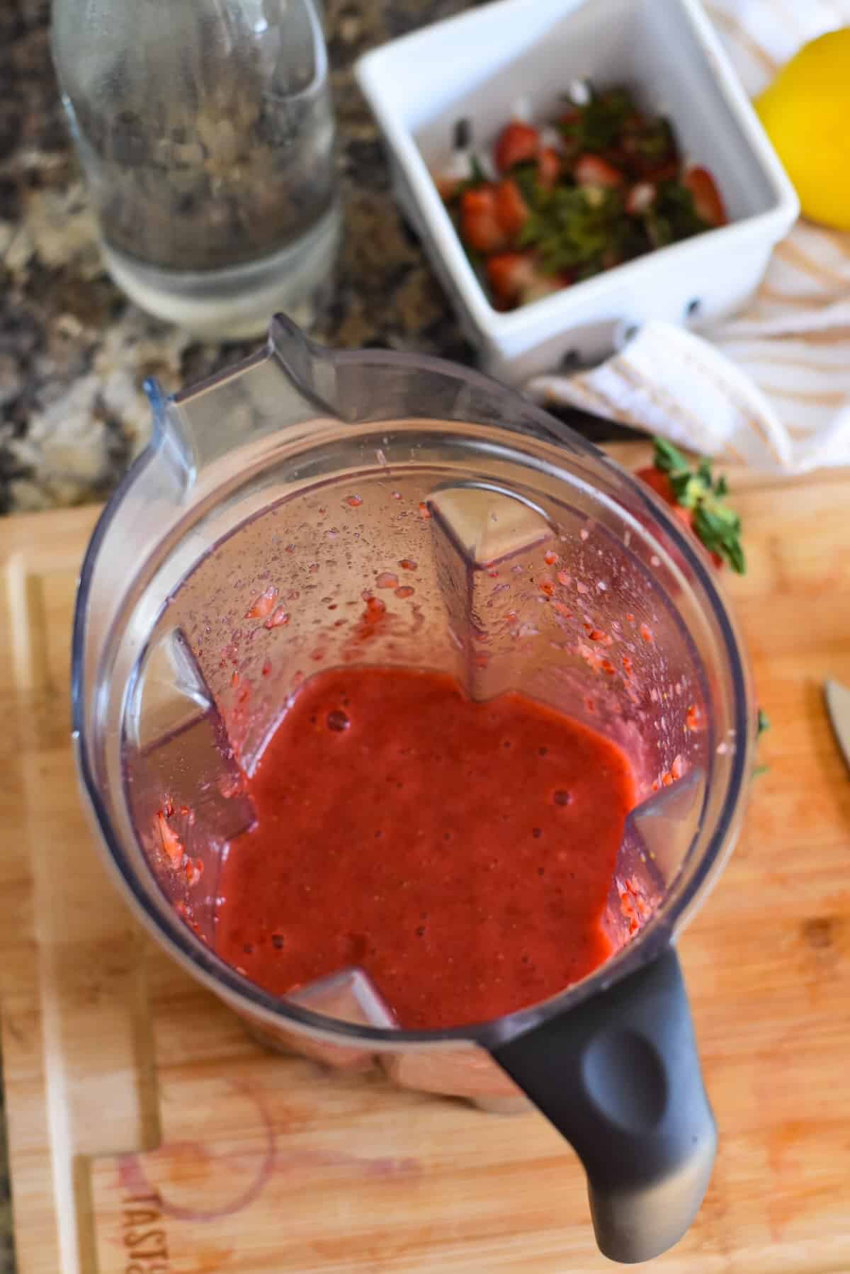 Pureed strawberries in a blender.