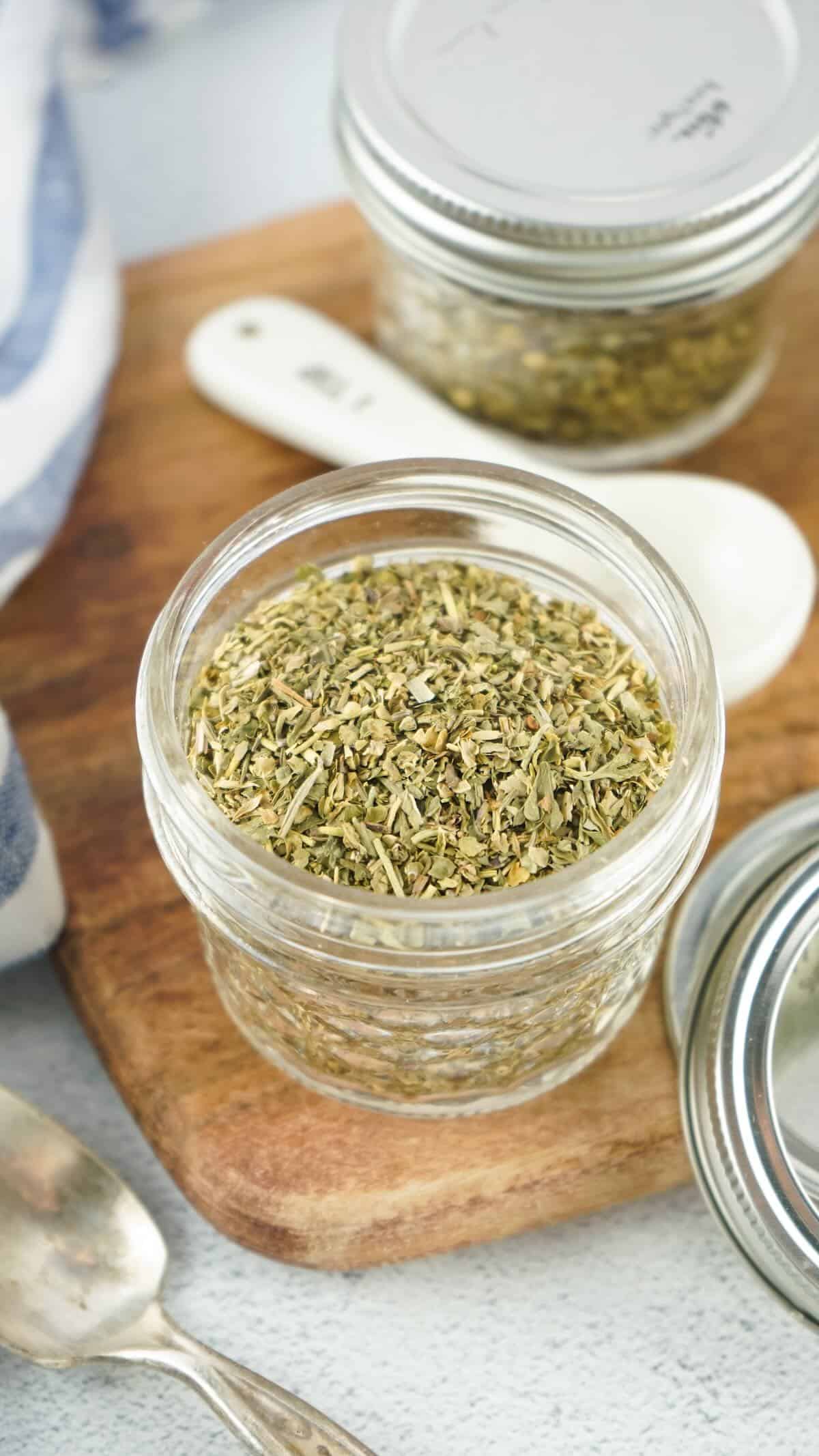 A glass jar with homemade seasoning blen inside.