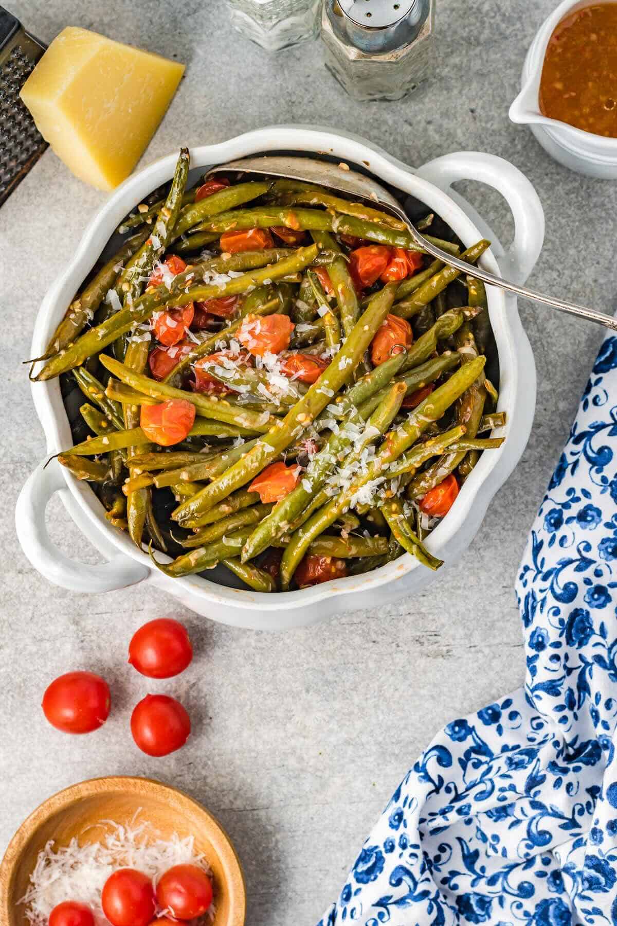 Close-up of oven-roasted Italian green beans topped with Parmesan, ready to serve.