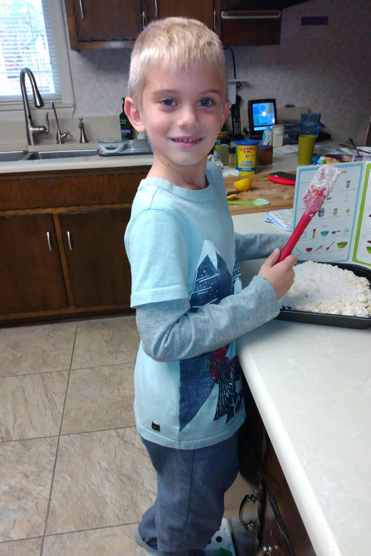 Pre-school boy helping to bake at Grandma's house.