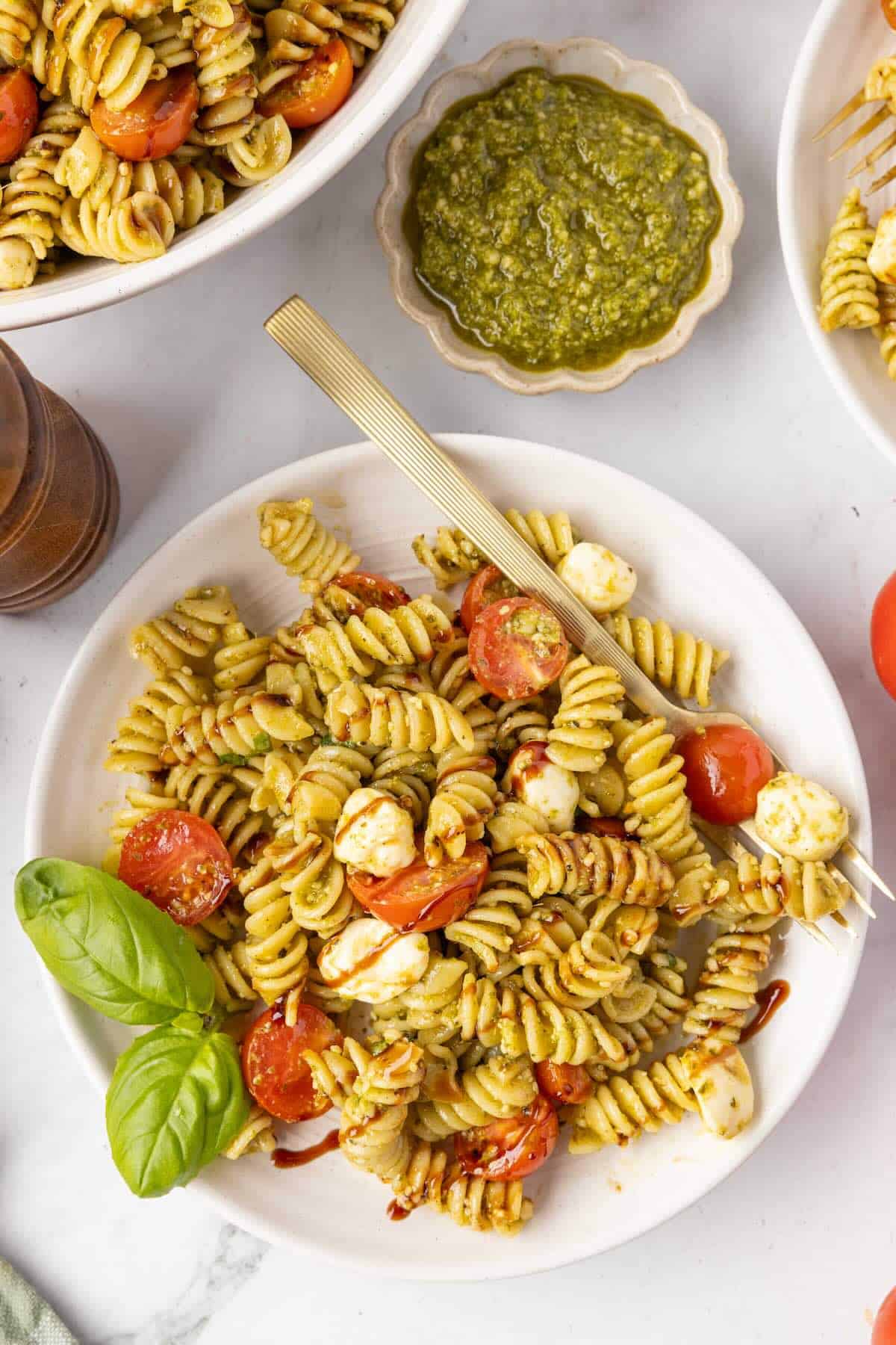 A serving of caprese pasta salad in a plate.