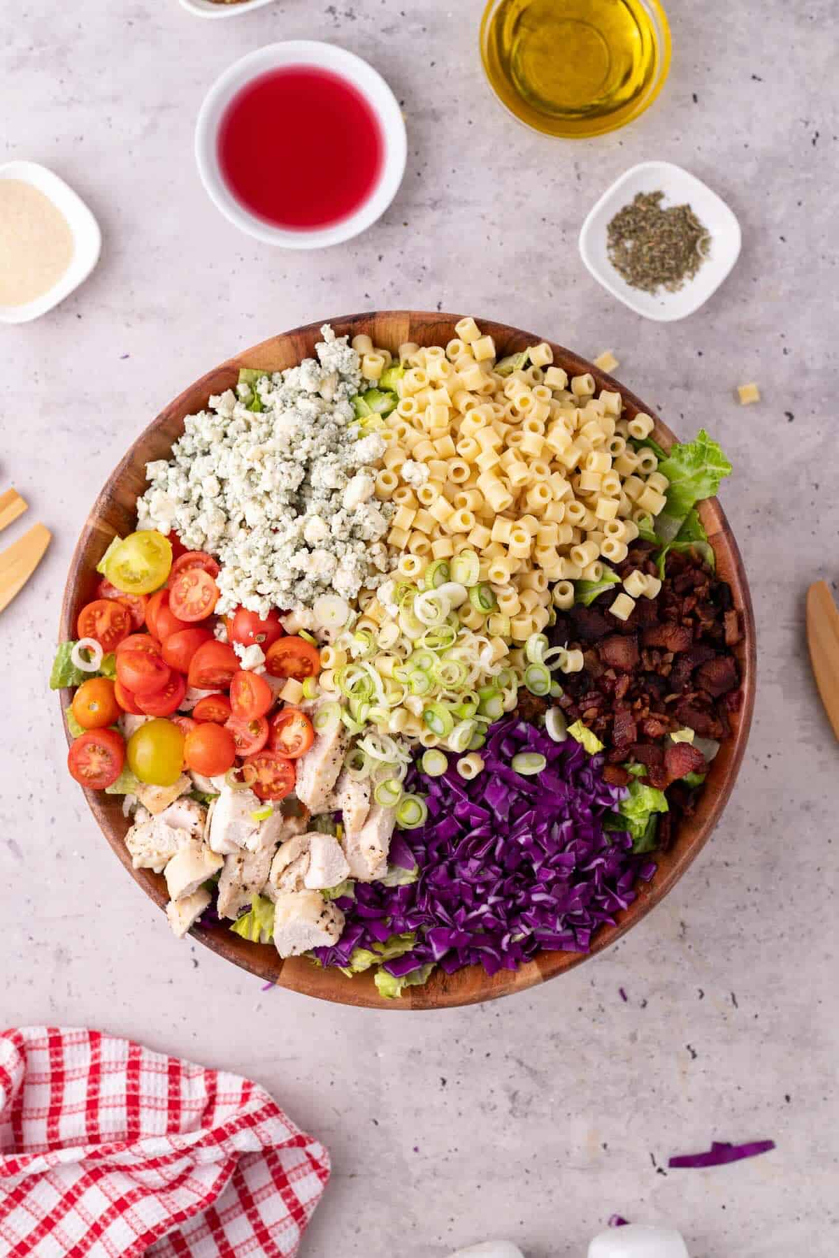 Chopped salad ingredients in a wooden serving bowl.