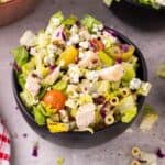 A salad bowl of Portillo's chopped salad topped with cheese.