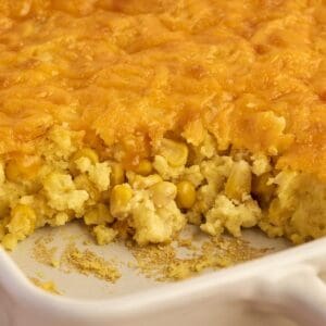 Baked cheesy corn casserole made with Jiffy corn muffin mix in a casserole dish, ready to serve.