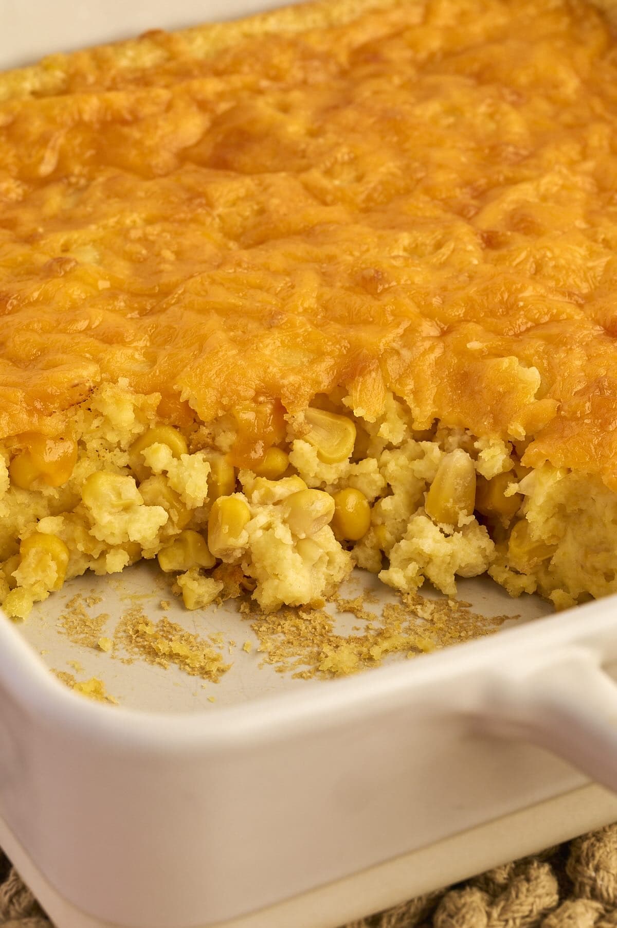 Baked cheesy corn casserole made with Jiffy corn muffin mix in a casserole dish, ready to serve.
